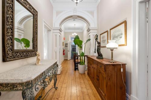 a hallway with a table and a mirror on a wall at Accommodation in Fremantle in Fremantle