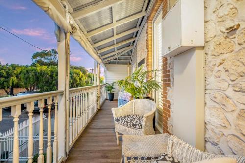 a balcony with wicker chairs and a window at Accommodation in Fremantle in Fremantle