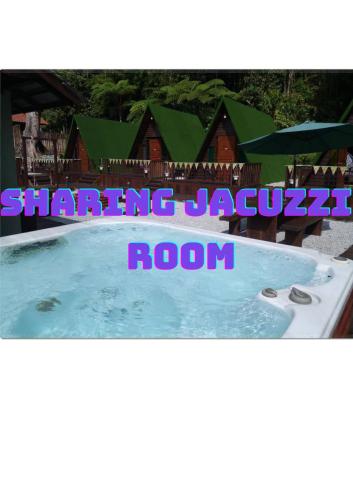 a picture of a swimming pool in front of a house at Rustcamps Glamping Resort in Genting Highlands