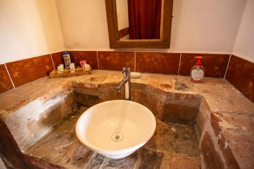 a bathroom with a stone counter with a sink at Cabaña Diego de Lucas 