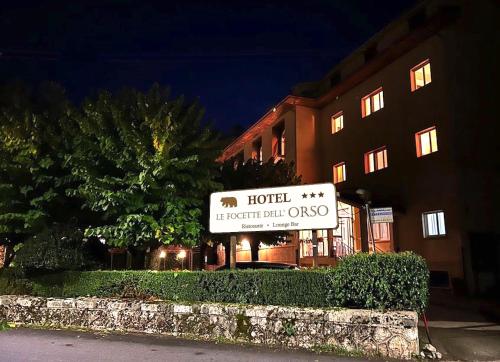 una señal de hotel frente a un edificio por la noche en Le Focette dell'Orso, en Scanno