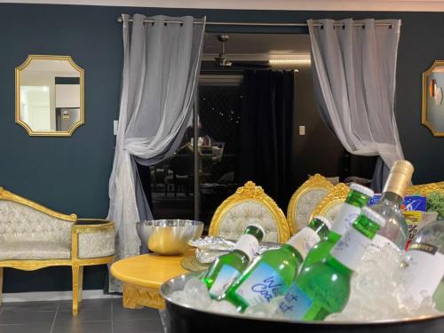 a room with a table with soda bottles on it at Royal Romanesque holiday house in Dakabin in Dakabin