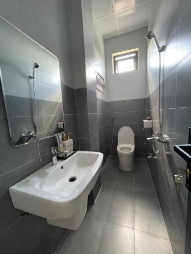 uma casa de banho com um lavatório e um WC em Nine Hotel Gia Lai em Pleiku