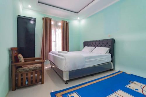 a bedroom with a large bed and a mirror at Erika Homestay in Lembang