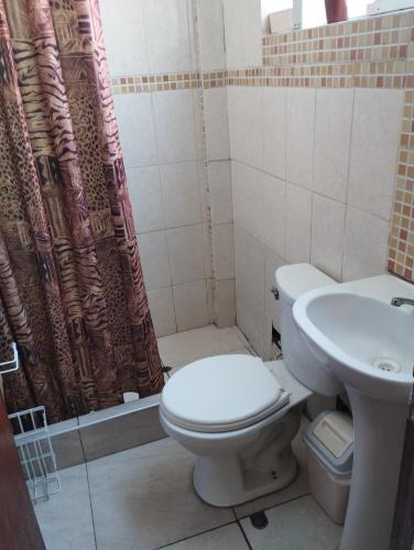 a bathroom with a toilet and a sink at Departamento Amoblado en Urba. Ilo in Ilo