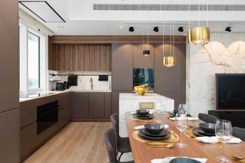 a kitchen and dining room with a table and chairs at Maison Privee - Deluxe 3BR Apt with Dubai Marina Vws & Beach Access in Dubai