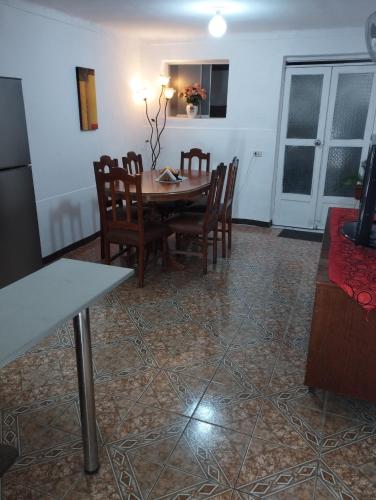 a dining room with a table and chairs at Departamento Amoblado en Urba. Ilo in Ilo