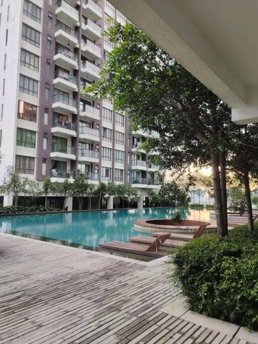 a large building with a swimming pool in front of a building at Urban360 studio lovely with Netflix and Wi-Fi in Batu Caves