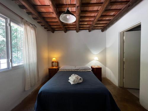 a bedroom with a bed with a blue blanket at Kasbah inn in La Cumbre