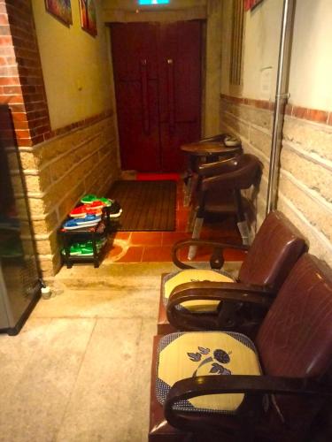 a room with two chairs and a door with a table at 作客七號 in Jincheng