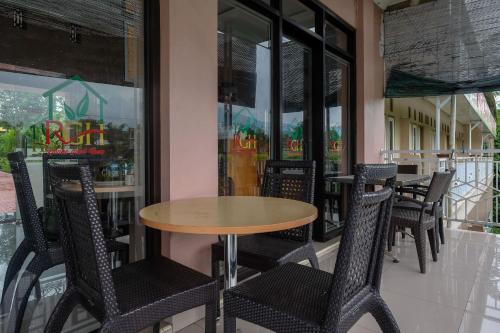 a table and chairs in front of a restaurant at RedDoorz Syariah near Taman Rekreasi Kalianget Wonosobo in Kalianget
