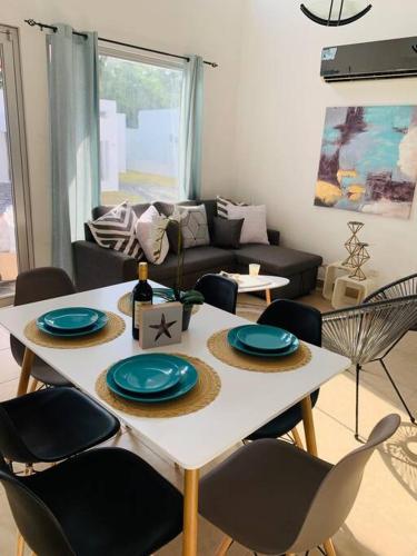 a living room with a white table and chairs at Enjoy a beautiful beach house in Panamá in Río Hato