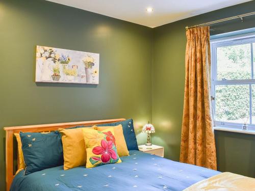 WingerworthにあるStone Cottageのベッドルーム(青いベッド1台、窓付)