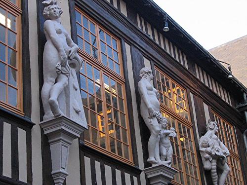a building with statues on the side of it at Les Roulottes de la Risle in Calleville