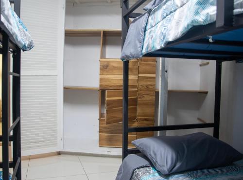 a bedroom with a bunk bed and a bunk room with a closet at Las Carmelas, Airport Juan Santamaría, Alajuela, San José in Alajuela City