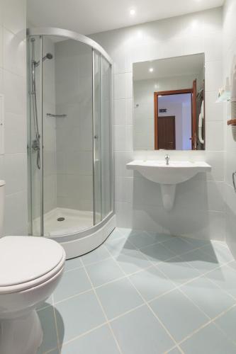 a bathroom with a toilet and a sink and a shower at Serena Residence Aparthotel in Sozopol