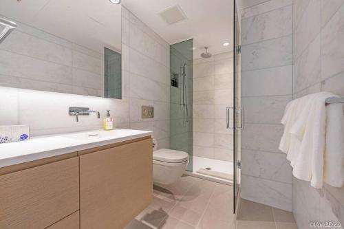 a bathroom with a toilet and a sink and a shower at Zero Waste NEW Luxury Studio-AC/pool/hottub/gym in Vancouver
