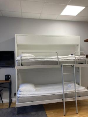 a room with two bunk beds in a room at Livin Station Hotel in Örebro