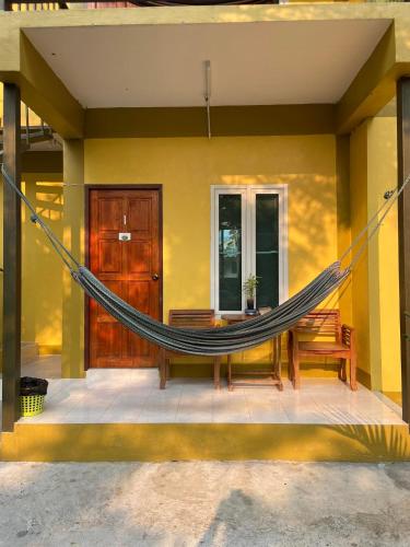a hammock on the front of a house at JJ&J Garden in Pai