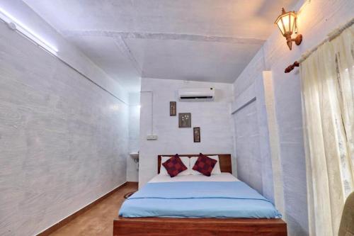 a bedroom with a bed in a white room at Waves and Shores Beach Villa in Mararikulam
