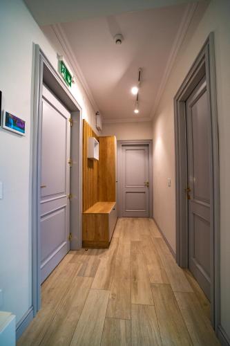 a hallway with two doors and a wooden floor at First Apartments in Focşani