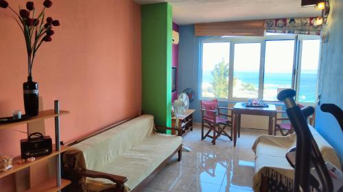 a living room with a couch and a room with a table at Joy View in Kavála