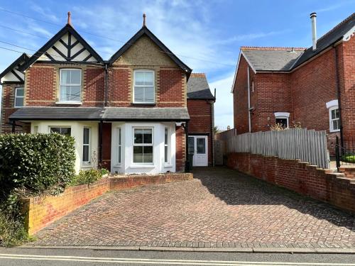 a brick house with a driveway in front of it at RedButt House, Freshwater, 3 Bedrooms, WiFi, Garden in Freshwater