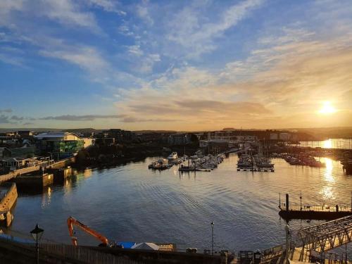 a view of a harbor with boats in the water at Apartment with a view, perfect for breaks and WFH in Plymouth