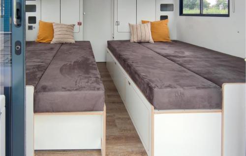 two beds in a room with a large couch at Gorgeous Ship In Havelsee Ot Ktzkow With Kitchen in Kützkow