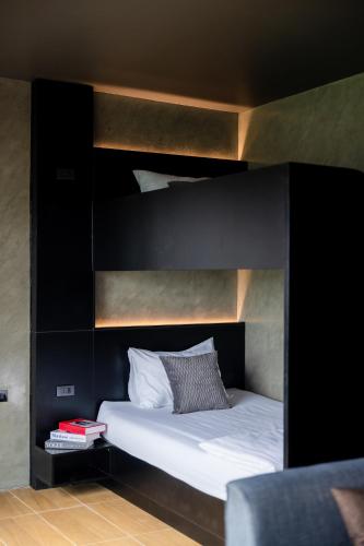 a bedroom with a bunk bed with white sheets and pillows at The View Chiang Dao in Chiang Dao