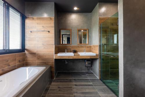 a bathroom with two sinks and a tub and a shower at The View Chiang Dao Hotel in Chiang Dao