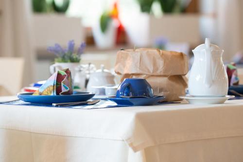 a table with plates and a bag on it at Hotel Erika in Malcesine
