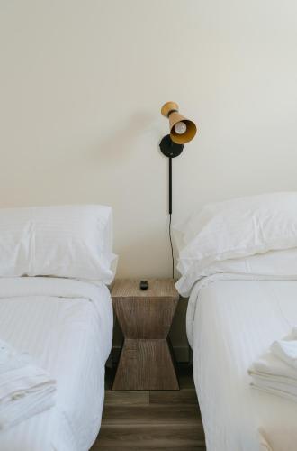 a bedroom with two beds and a lamp on a night stand at The Shore House in Wildwood