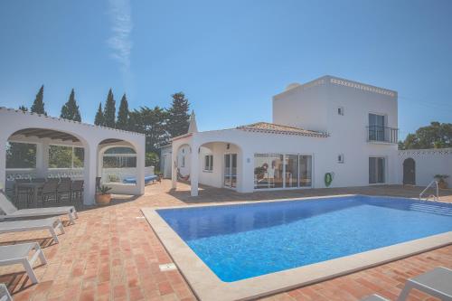 a villa with a swimming pool and a house at Casa Monte Cristo IV in Lagos