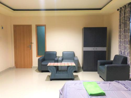 a hospital room with two chairs and a table at MS Hotel Pinrang Mitra RedDoorz in Pinrang