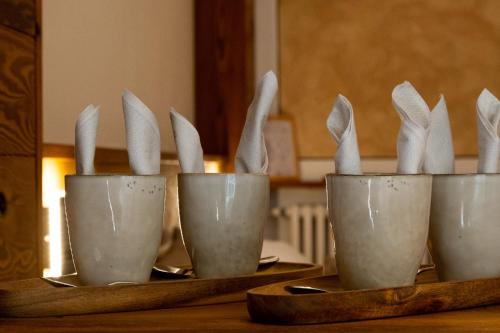 a group of white rabbits in cups on a table at Albergo San Carlo in Ormea