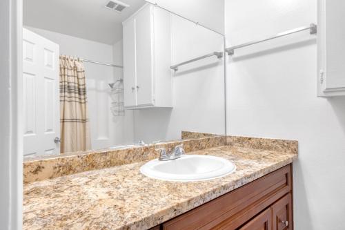 a bathroom with a sink and a mirror at Woodland Hills 2BR w Pool Gym nr Warner Center LAX-699 in Los Angeles