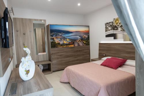 a bedroom with a bed and a tv in it at Mary Vi Rooms in Peschici