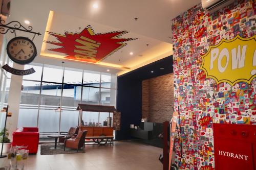 a lobby with a wall covered in lots of stickers at Hotel 88 Bekasi By WH in Bekasi