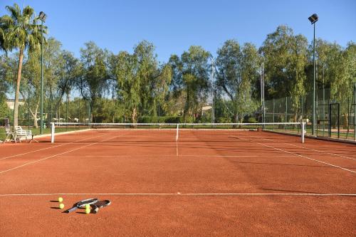 a tennis court with a tennis ball laying on the court at Iberostar Waves Club Palmeraie Marrakech All Inclusive in Marrakech