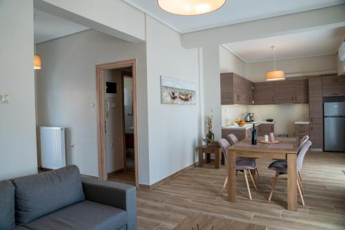 a living room and kitchen with a table and chairs at Sea View Volos in Volos