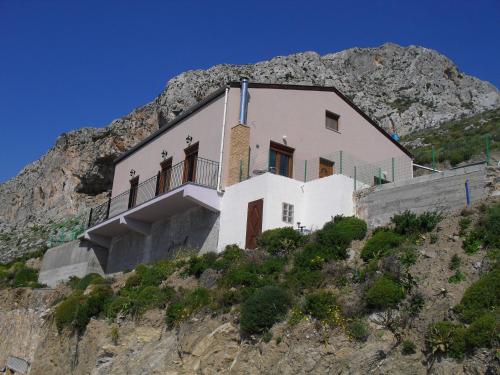 a house on the side of a mountain at la villa de Rose in Kalymnos
