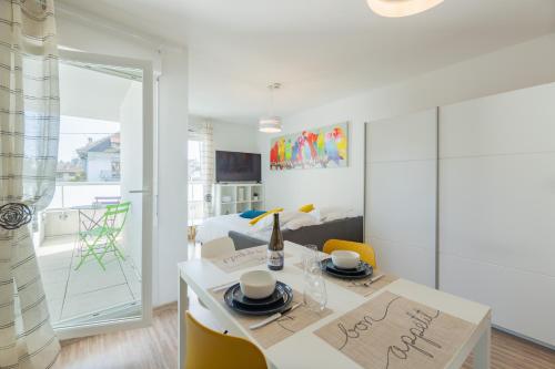 uma sala de estar com uma mesa de jantar e uma cozinha em Studio Cosy les Perruches em Thonon-les-Bains