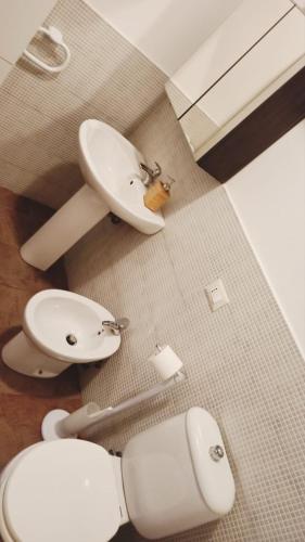 a bathroom with two toilets and a sink at La Picci in Catania