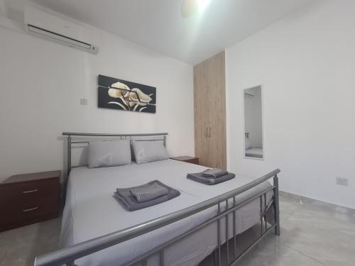 a bedroom with a bed with two pillows on it at Pindarou Apartment in Nicosia