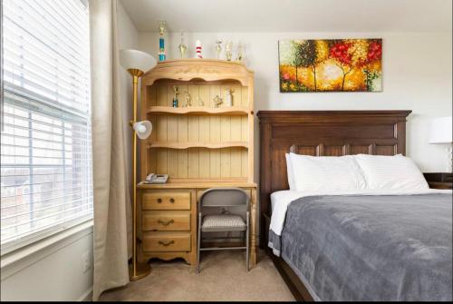 a bedroom with a bed and a wooden book shelf at Van Gogh Guest Rm #3 • Van Gogh 3-Comfy Private Rm in single family home in Rosedale