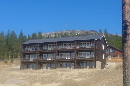 un grand bâtiment au milieu d'un champ dans l'établissement Björnrike Vemdalen. Mitt i backen, à Vemdalen