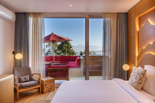 a hotel room with a bed and a balcony at The Terraces Resort and Spa in Bhaktapur