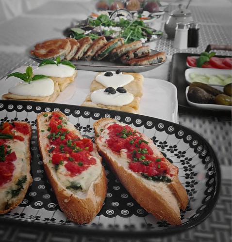 a table with a plate of sandwiches and other foods at FORMA Apartament Supraśl in Supraśl