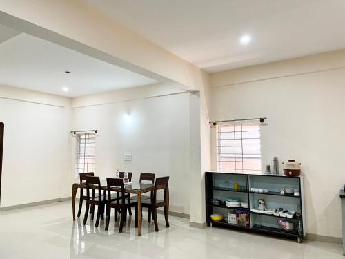 a dining room with a table and chairs at The INN in Mysore